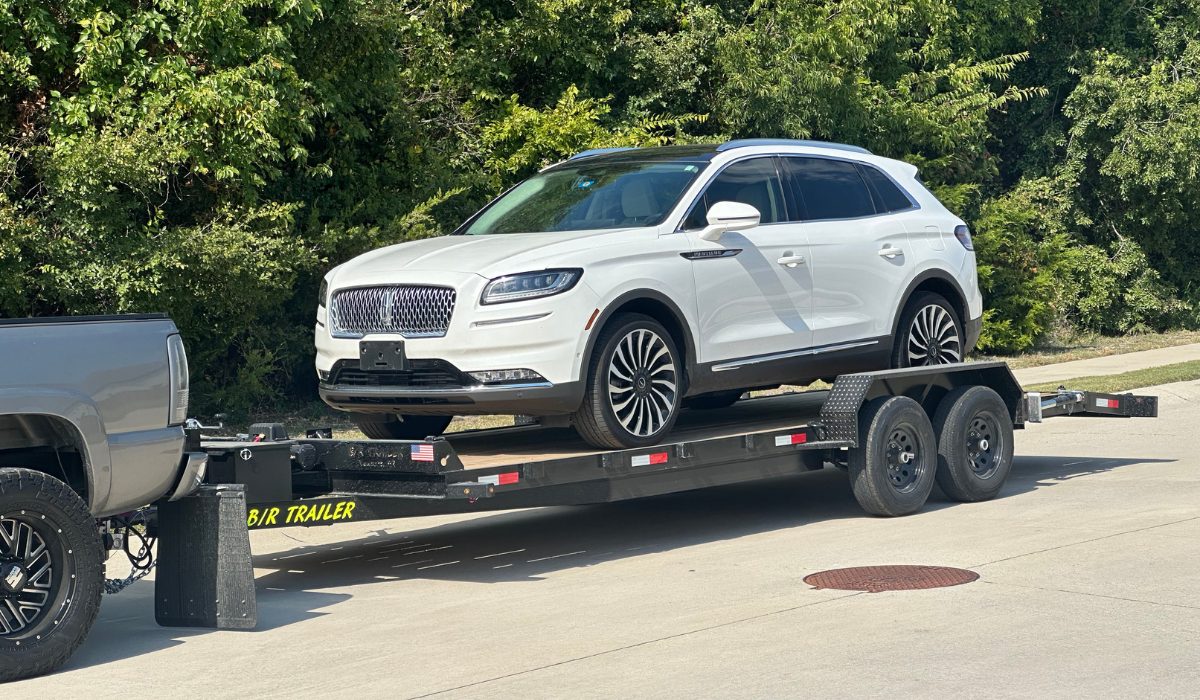 The Trailer Rental Guys, car hauler loaded with a vehicle in Rockwall, TX